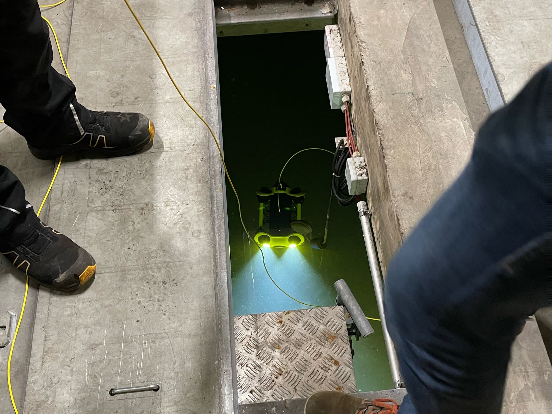 Underwater drone inside concrete sprinkler tank in ground