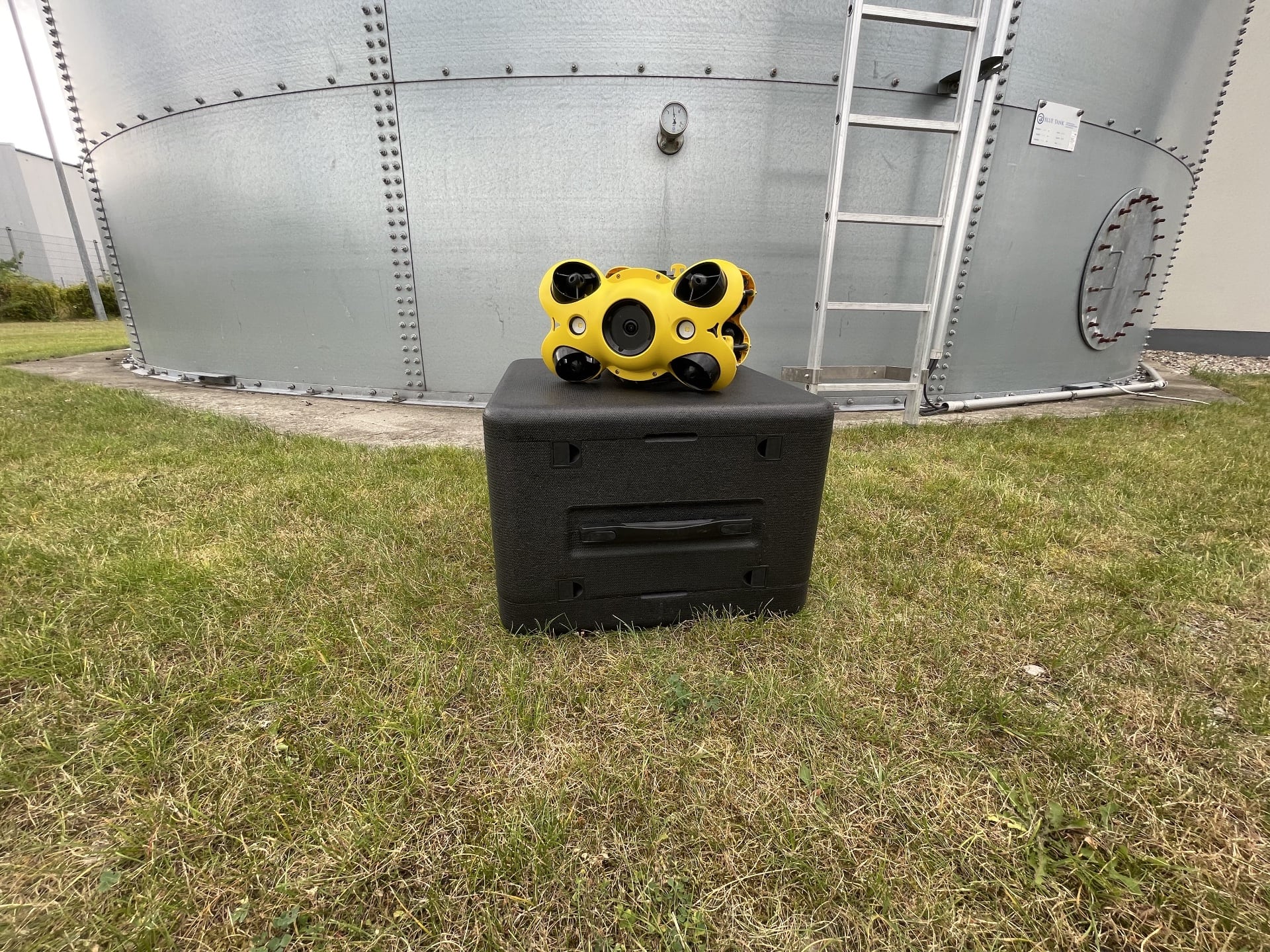 Underwater drone in front of sprinkler tank
