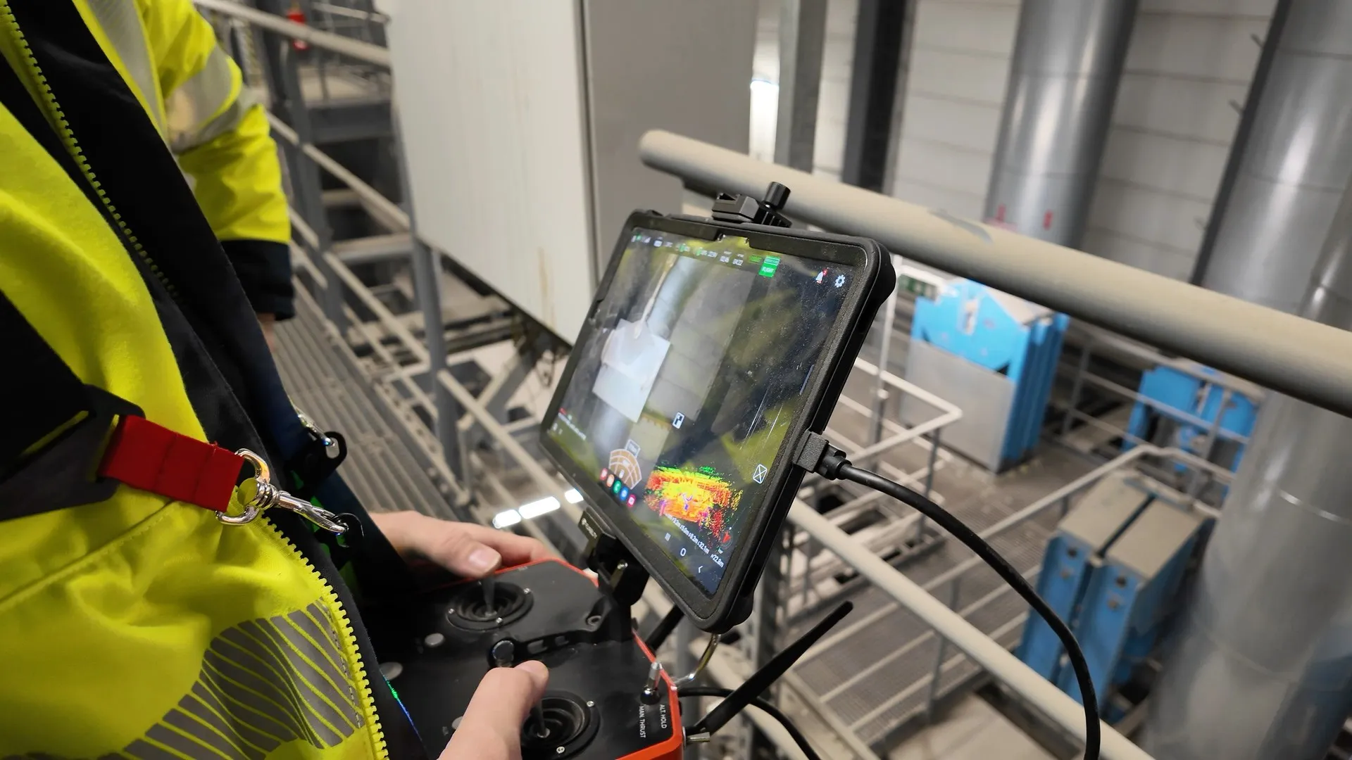 Christian Engelke operating the Flyability ELIOS 3 drone controller during an industrial inspection